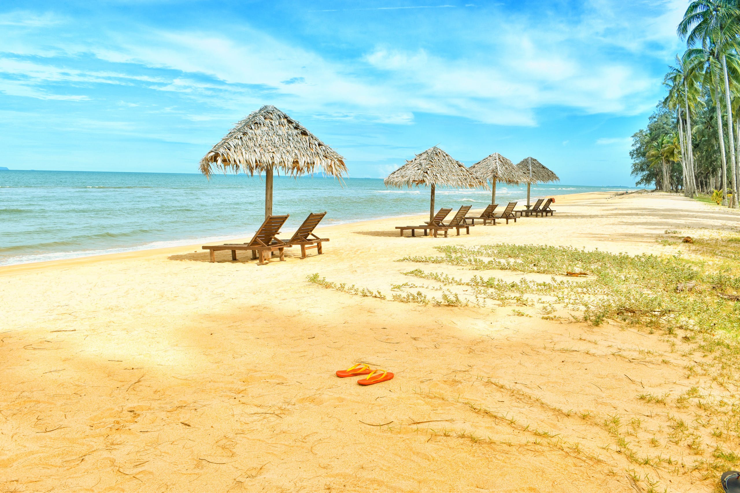 Loungers Under Parasol at Shoreline